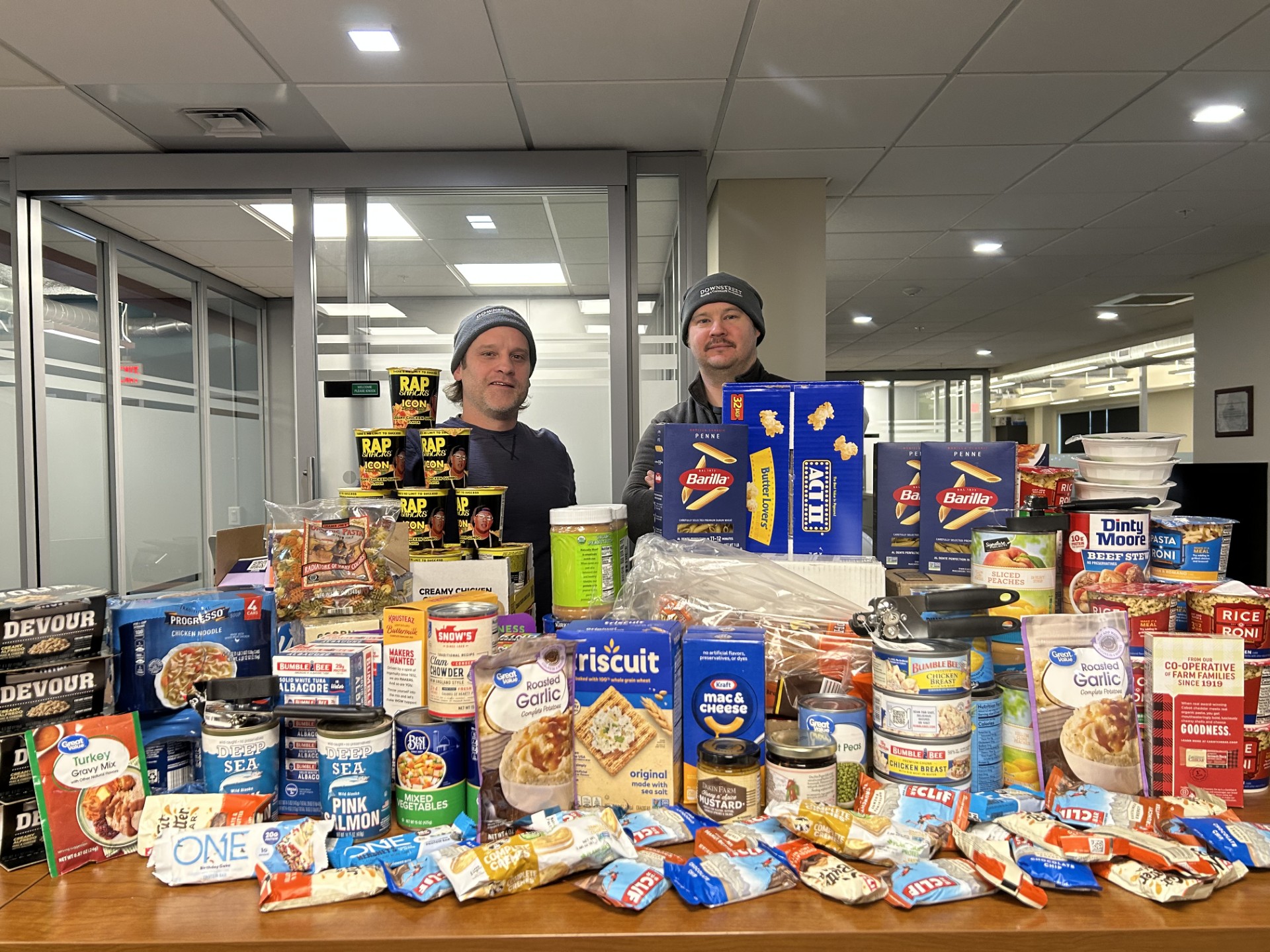 Image of Downstreet staff with food collected for a food drive